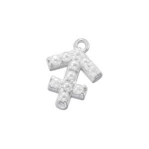 Close-up of silver Sagittarius pendant with white pearl inlay for jewelry making