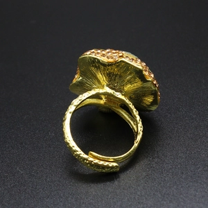 Macro shot of gold vintage ring featuring textured band and cluster of purple crystals