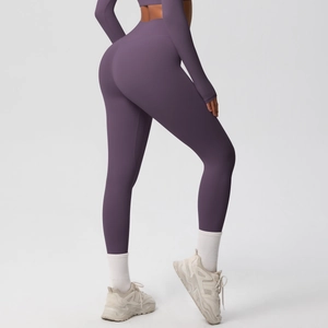 Close-up of deep purple high-waisted yoga pants showing stretch fabric and slimming fit