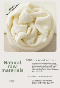 Close-up of white combed cotton knit fabric showing premium ribbed texture and softness