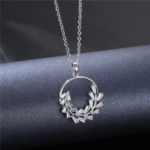 Elegant silver necklace with a circular leaf pendant inlaid with zircon crystals