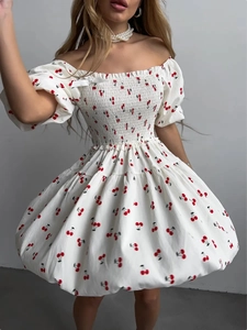Detailed view of cherry print mini dress with smocked bodice and balloon hem