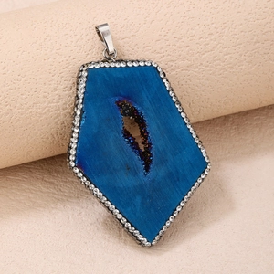 Macro detail of deep blue druzy stone pendant with crystal cavity and rhinestone border