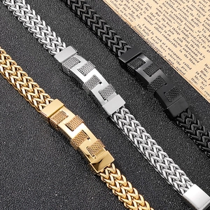 Detailed shot of woven stainless steel men's bracelets in gold, silver and black metal