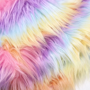 Macro detail of the fluffy rainbow gradient faux fur material with soft pastel textures