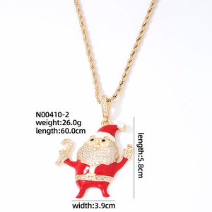 Macro detail of gold Santa pendant with red enamel, white zircons, and size dimensions