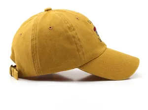 Side view of ginger cotton baseball cap showing adjustable metal buckle and embroidery