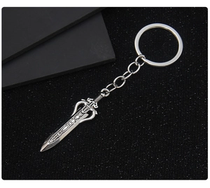 Close-up of a silver bronze sword keychain with intricate vintage metal textures and links