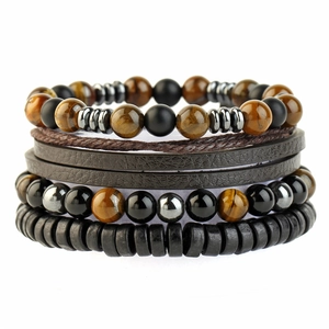 Detail of multi-layer bracelet set with tiger eye, hematite, and braided leather texture