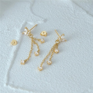 Close-up of S925 sterling silver gold earrings with floral zircon and tassel chains