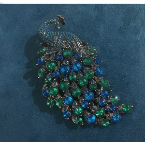 Detailed view of vintage peacock brooch with vibrant blue and green crystal rhinestones