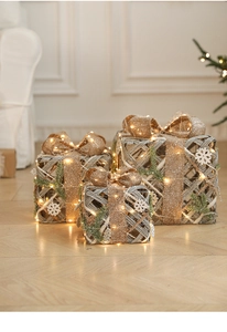 Set of three champagne iron Christmas gift boxes with burlap bows and warm LED lights