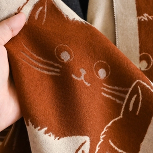 Close-up of thick knit cat pattern shawl showing soft cashmere-like texture and details