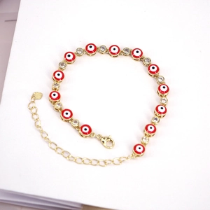 Bohemian gold chain bracelet with red evil eye charms and sparkling zircon accents