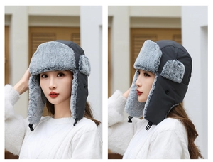 Detail of warm winter trapper hat featuring windproof fabric and thick faux fur earflaps