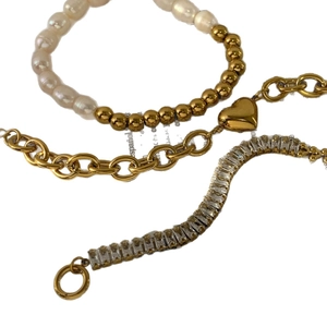 Three-piece layered gold bracelet set with freshwater pearls, heart pendant and zircon stones