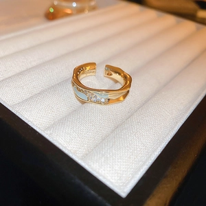 Close-up of gold-plated dragon ring with light blue enamel and micro-pave zircons