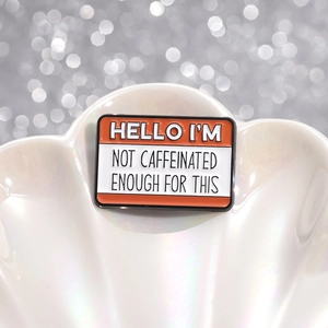Orange rectangular enamel coffee brooch pin with funny quote on a white shell plate