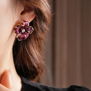 Vintage purple enamel flower earrings with crystal center and gold-plated diamond edges