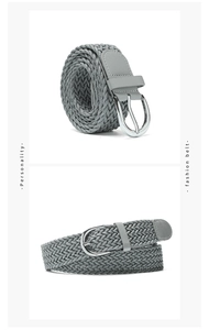 Detail of grey braided elastic belt featuring a silver pin buckle and leather finishes