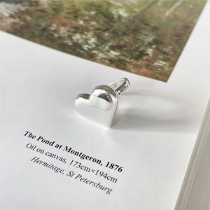 Polished 925 sterling silver heart-shaped open ring displayed on an artistic background