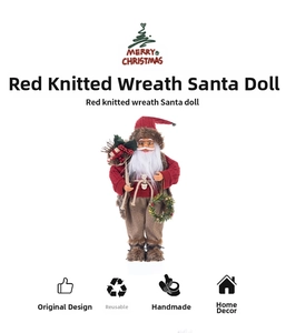 Detail of Santa Claus figurine wearing a red knitted sweater holding a festive wreath