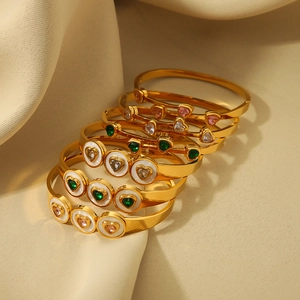Gold plated titanium steel bangles with white shell hearts and colorful zircon crystals