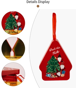Detail display of a red Christmas house tin box with lanyard and gnome printing