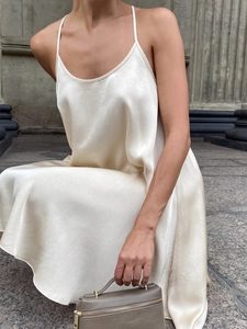Elegant ivory satin slip dress with minimalist spaghetti straps in a fluid silk-like finish