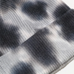 Close-up of ribbed knit texture on tie-dye beanie with black, grey, and white blend