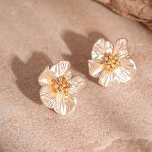 Elegant floral stud earrings with pearl petals and golden cubic zirconia centers