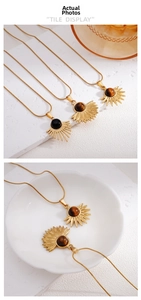 Close-up of bohemian sunburst pendants with tiger eye and obsidian on gold chains