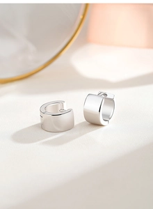Macro shot of 925 sterling silver hoop earrings with polished mirror finish surface
