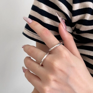 Close-up of a minimalist S925 sterling silver double-layer open ring on a female finger