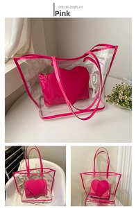 Detailed view of pink heart-shaped inner pouch and clear PVC tote bag with handles
