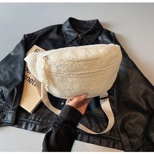 Detail of white sherpa fleece fanny pack with half-moon shape and braided zipper pull