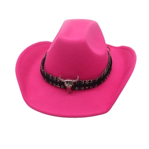 Detail view of hot pink cowboy hat featuring an ethnic woven band and silver bull head