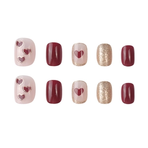 Short square press-on nails in burgundy, pink heart patterns, and gold glitter set