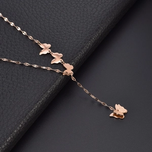 Rose gold butterfly necklace with matte finish pendants on premium leather background