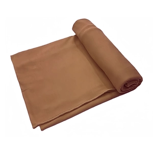 Detail of folded terracotta milk silk turban wrap fabric with soft textile texture
