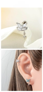 Detailed butterfly cartilage earring with zircon stones and star charms on an ear model