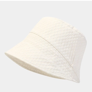 Chic cream-white bucket hat with textured wavy pattern for sun protection and style