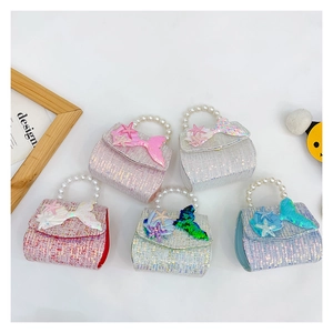 Detail of sequin mermaid princess bags with pearl handles in five vibrant pastel colors