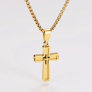 Detailed view of a gold double-layer cross pendant with a box chain on white background