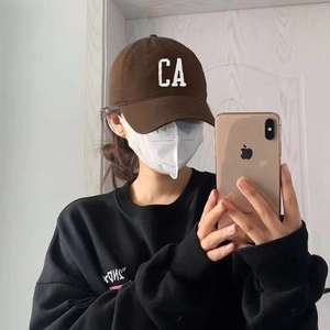 Brown cotton baseball cap with CA embroidery in a stylish mirror selfie view