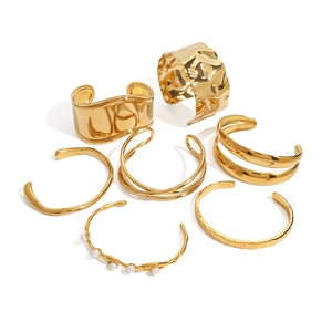 Set of gold stainless steel open cuff bracelets with pearl accents and hammered texture