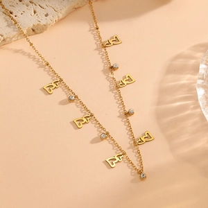 Detail of 18K gold-plated heart necklace with hollow pendants and cubic zirconia accents