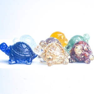 Macro shot of colorful crystal turtle figurines with clear resin and gold foil flakes