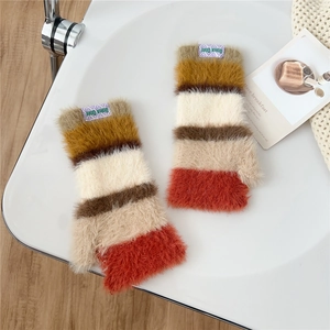 Detail of colorful striped fingerless gloves with fuzzy texture and purple brand label