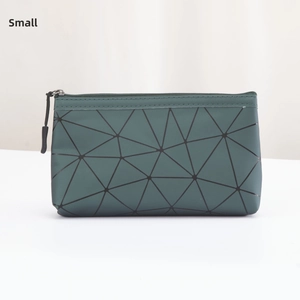 Detail view of the small green PU cosmetic bag with geometric triangle pattern